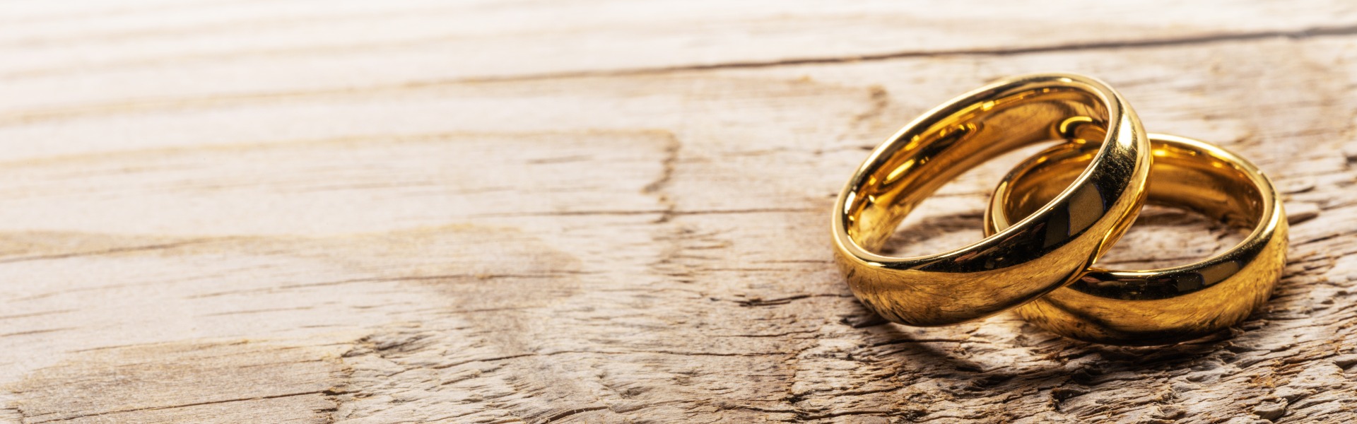 Golden wedding rings on wood